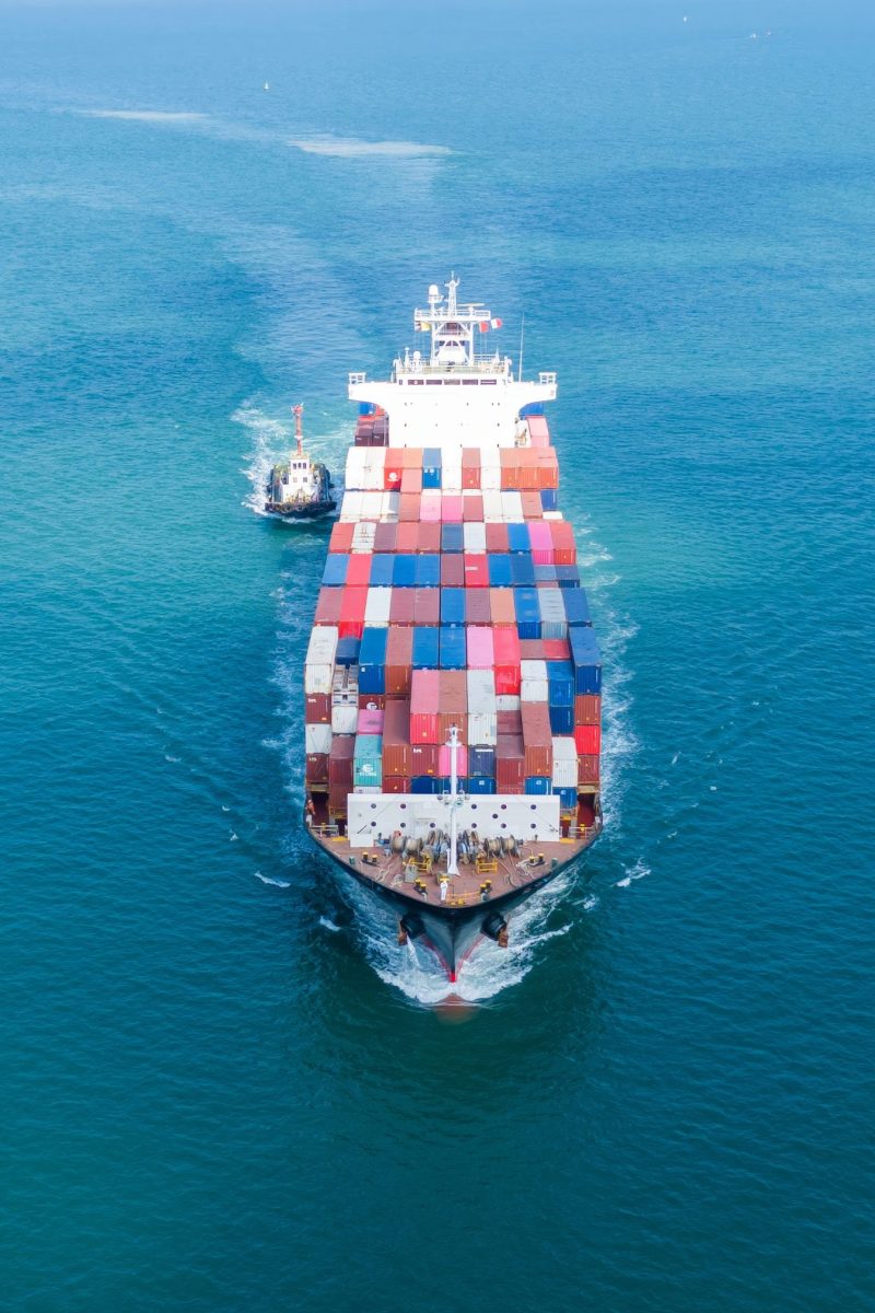 Cargo Container Ship was pulling by Tugboat. container ship impo Cargo Container Ship was pulling by Tugboat. container ship import export to customers sea port. export shipping industry freight and transportation logistics concept